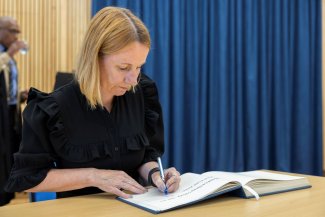 Michelle Mitchell signing the Fellows' Book