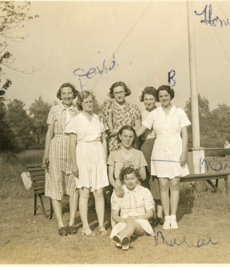 Group shot of 7 women students, with Margaret kneeling